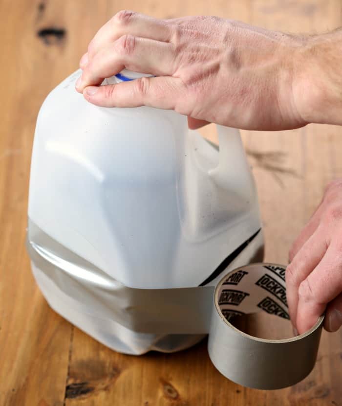 using duct tape to tape seam of milk jug