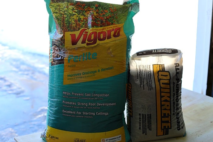 a bag of yellow and green vigoro perlite next to a smaller bag of quickrete all purpose sand.