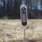 soil temperature reading using a soil thermometer that is probing the middle of a lawn